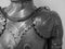 Grayscale closeup shot of the details of a medieval knight armor