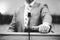 Grayscale closeup shot of a male speaking  from podium Holy Bible  hold in hand