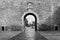 Grayscale shot of an ancient door of Puerta Nueva de Bisagra in the old wall of Toledo, Spain