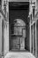 Grayscale shot of an arch entrance gate door of a building