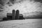 Grayscale shot of a barn with two silos in winter Wisconsin