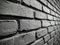 Grayscale shot of a beautiful brickwork wall- perfect for a cool background
