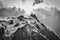 Grayscale shot of the famous Aiguille du Midi mountain covered with snow in France
