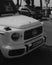 Grayscale shot of a front part of a white Mercedes Brabus car on Cannes Boulevard in France