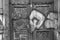 Grayscale shot of graffiti on wooden entrance doors