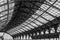 Grayscale shot of the metal lattice roof of Brighton railway station, England