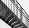 Grayscale shot of metal turning stairs