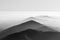 Grayscale shot of the misty Black Mountains in Wales