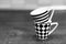 Grayscale shot of mugs with striped and chess tile patterns