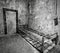 Grayscale shot of an old prison cell at Eastern State Penitentiary in Philadelphia, Pennsylvania