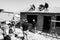 Grayscale shot of people building a low cost house in Soweto