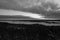 Grayscale shot of Tolkuse Raba landscape under a cloudy sky in Estonia