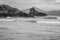 Grayscale shot of waves coming in on MacKenzie Beach in Tofino, Canada