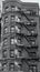 Grayscale vertical shot of an old city building with beautiful architecture