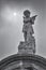 Grayscale vertical shot of a sculptured angel in New Orleans Cemetery