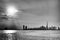 Grayscale view of the skyline of Dubai city from the sea at sunset, United Arab Emirates