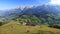 Grazing cattle in front of a mountain hut with mighty mountains in the background