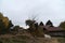 A grazing horse, camp site and rest huts at Tshoka, a rest-stop along the Goechala Trek, Kanchenjunga National Park, Sikkim