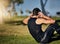 Great abs dont just happen. a young man in gymwear working out in a park.