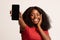 Great App. Amazed Black Female Demonstrating Smartphone With Big Blank Screen