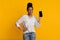 Great App. Millennial Afro Woman Holding Smartphone With Blank Black Screen