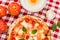 Great background for culinary themes, handmade pizza with daisy flavor on checkered Italian style towel background with different