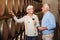 This is a great batch. an affectionate senior couple wine tasting in a cellar.