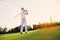 Great blow. A man in a white suit plays golf. he is pleased with his blow