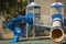 Great blue slide in a children\'s playground, modern example of how kids can play safe and have lot fun.