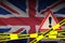 Great britain flag and Covid-19 quarantine yellow tape. Coronavirus or 2019-nCov virus