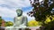 The Great Buddha Daibutsu, a view through the autumn leaves, is a lanmak and the sacred site is located in Kotokuin Temple.