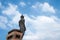 The great Buddha statue in standing pose, viewed from the back-side with sky background