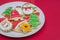 Great christmas background, christmas biscuits on white plate with red background
