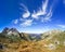 Great clear view in the mountain with beautiful clouds. Alps.