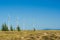 Great concept of renewable, sustainable energy. Wind field with wind turbines, producing aeolian energy under blue sky