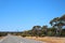 Great Eastern Highway with flowering trees and bushes at roadside, Western Australia