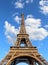 Great Eiffel Tower with blue sky and white clouds in vertical