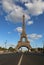 Great Eiffel Tower and the street with few cars in Paris