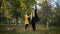 Great family, handsome mother with a lovely little kid, playing in autumn leaves with an umbrella walking in park in