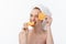 Great food for a healthy lifestyle. Beautiful young shirtless woman holding piece of orange standing against white