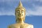 Great Golden Buddha statue in the temple with blue sky and white cloud