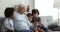 Great-grandfather and grandsons watching online content using smartphone