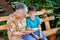 A great-grandmother reads a book to the great-grandchild