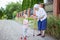 Great grandmother and toddler girl picking flowers outdoors