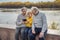 Great-grandson teaches great-grandfather and great-grandmother how to use the phone. Old people and technology concept