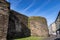 Great medieval stone wall surrounding the city next to the road. Galician city of Lugo, Spain