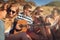 Great memories with great friends. a group of young friends hanging out together on a summers day at the beach.