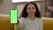 Great mobile app. Close up shot of modern smartphone with green chroma key screen in woman's hand, empty space