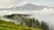 Great mountains of the Carpathians and spruce forests are haze-covered on sunny day. Timelapse.