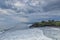 Great nature view of a beach in Tanah Lot Bali with waves hitting it during bad weather with negative space. Motion blur effect